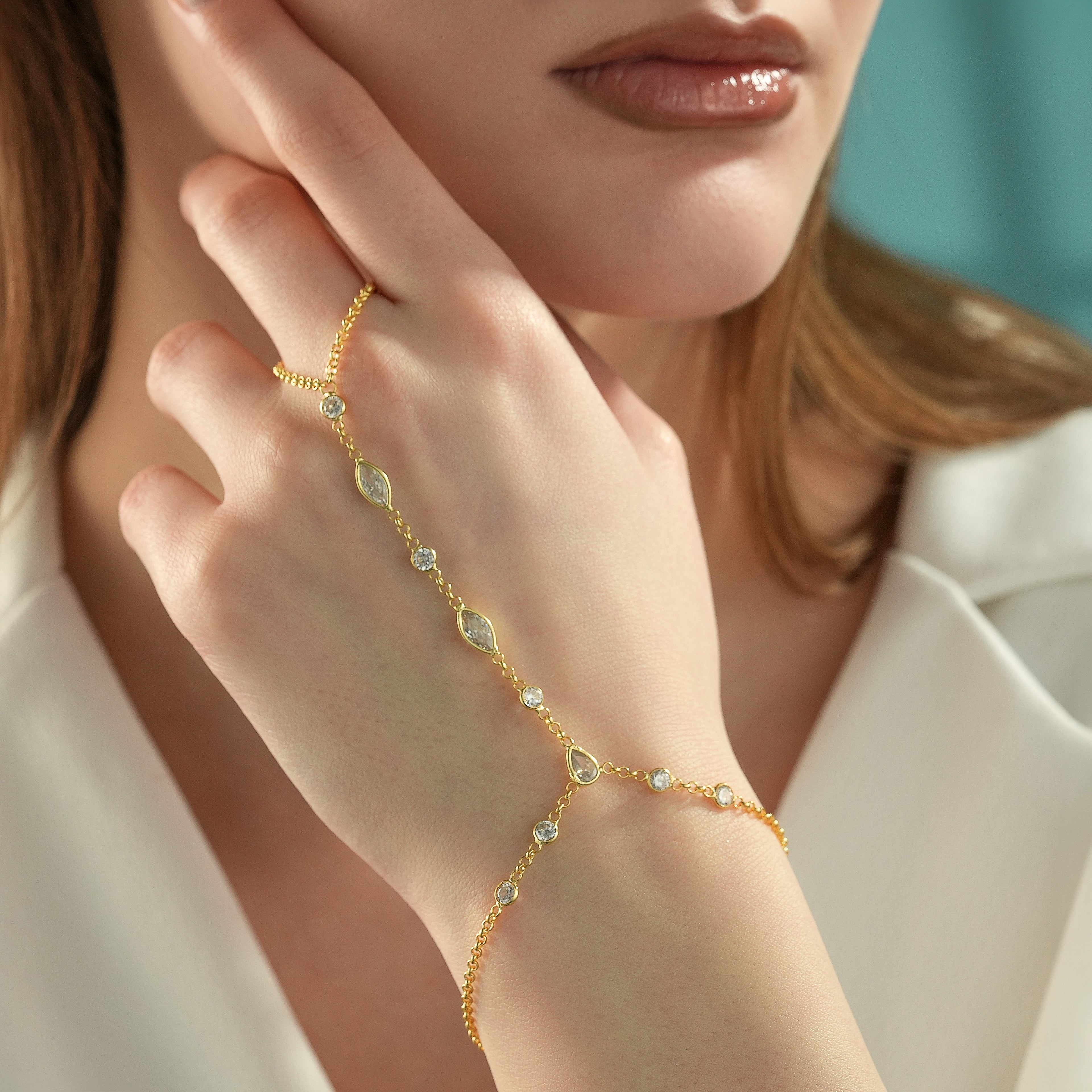 Close-Up of 14K Gold Plated Hand Chain Bracelet on Hand with Clear CZ Stones