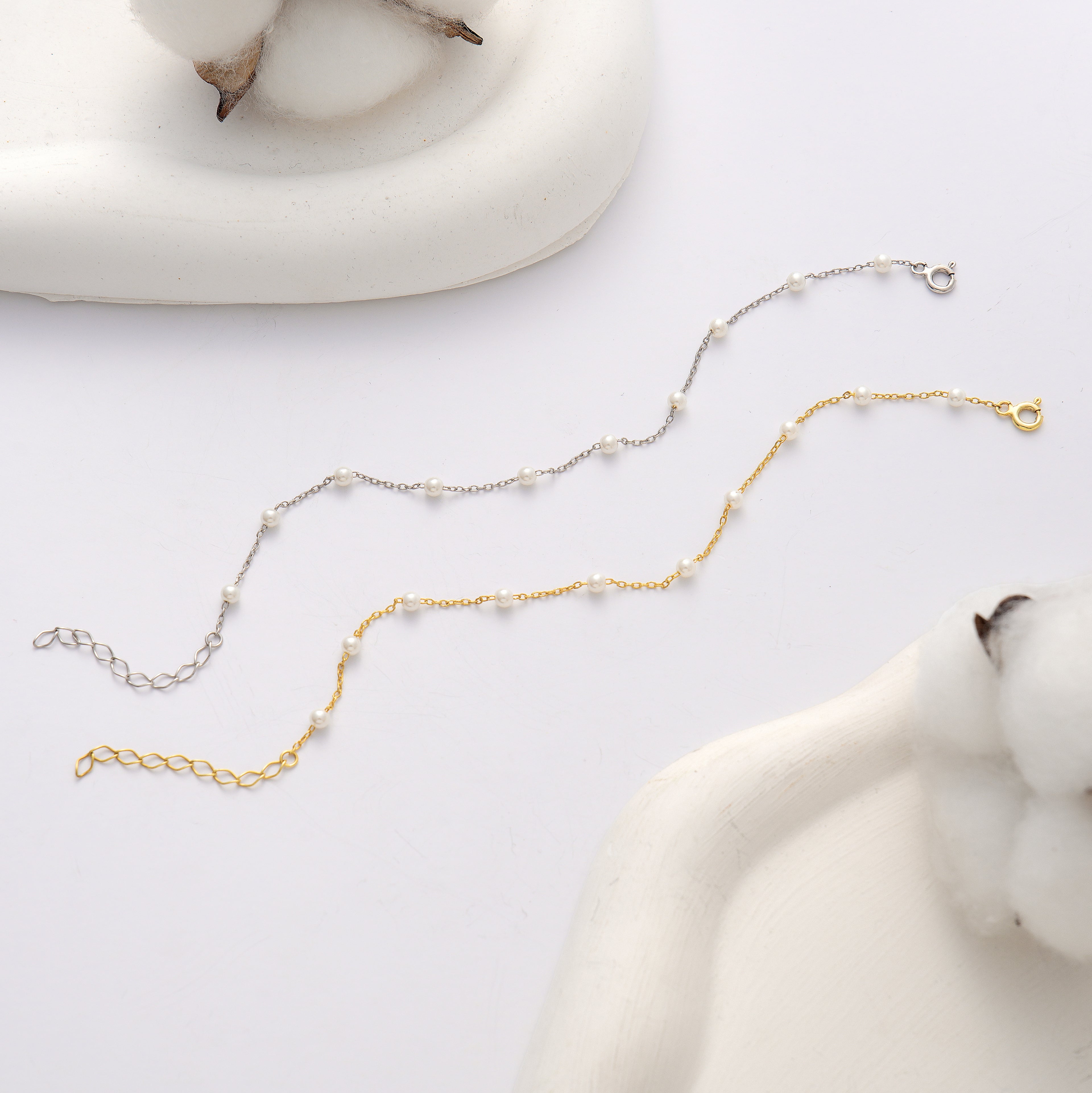 925 sterling silver pearl chain bracelet available in sterling silver and 14K gold plated finishes, featuring evenly spaced white pearls, lobster clasps, and adjustable extension chains.