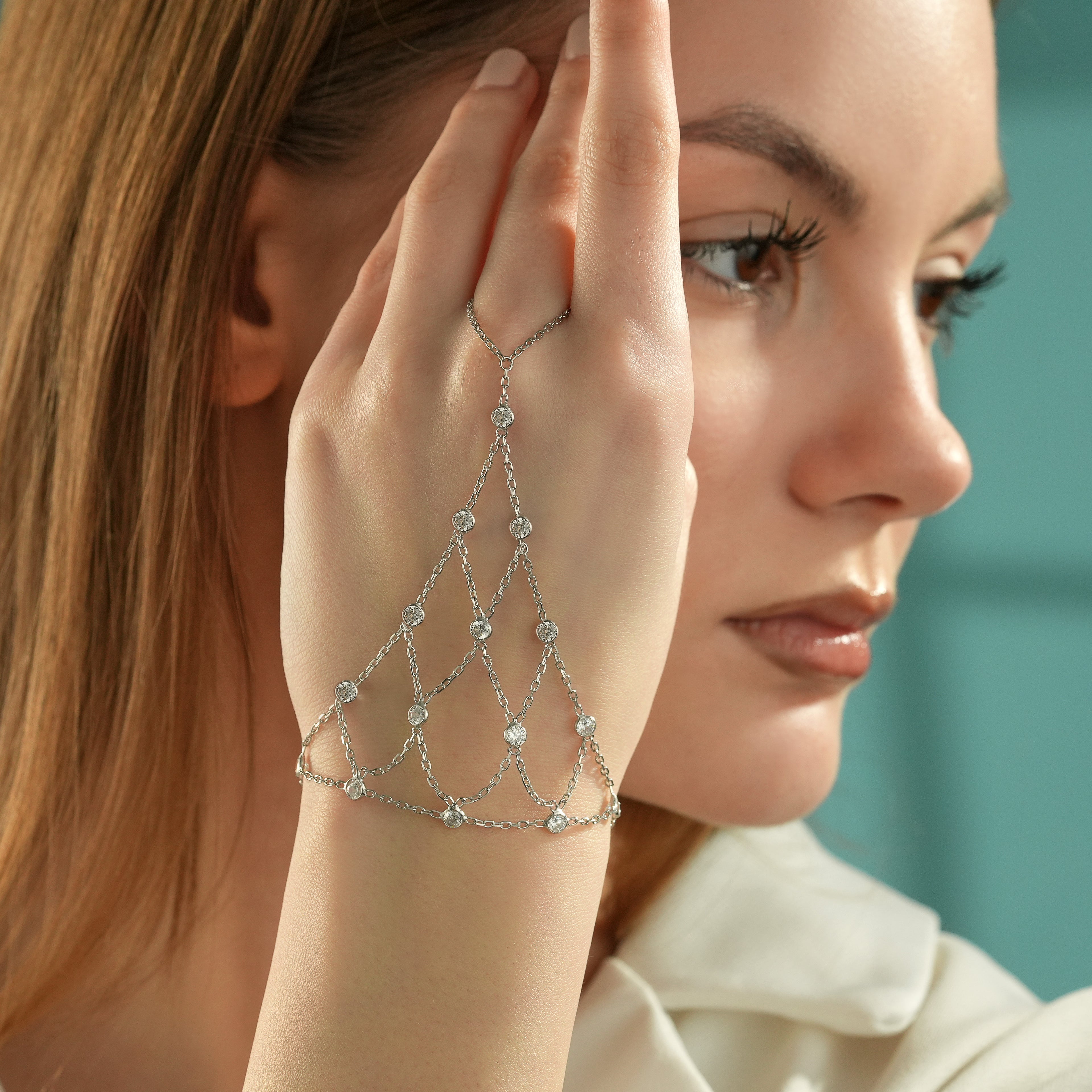 Close-up of a 925 sterling silver hand chain bracelet featuring multiple layered chains with bezel-set cubic zirconia stones.