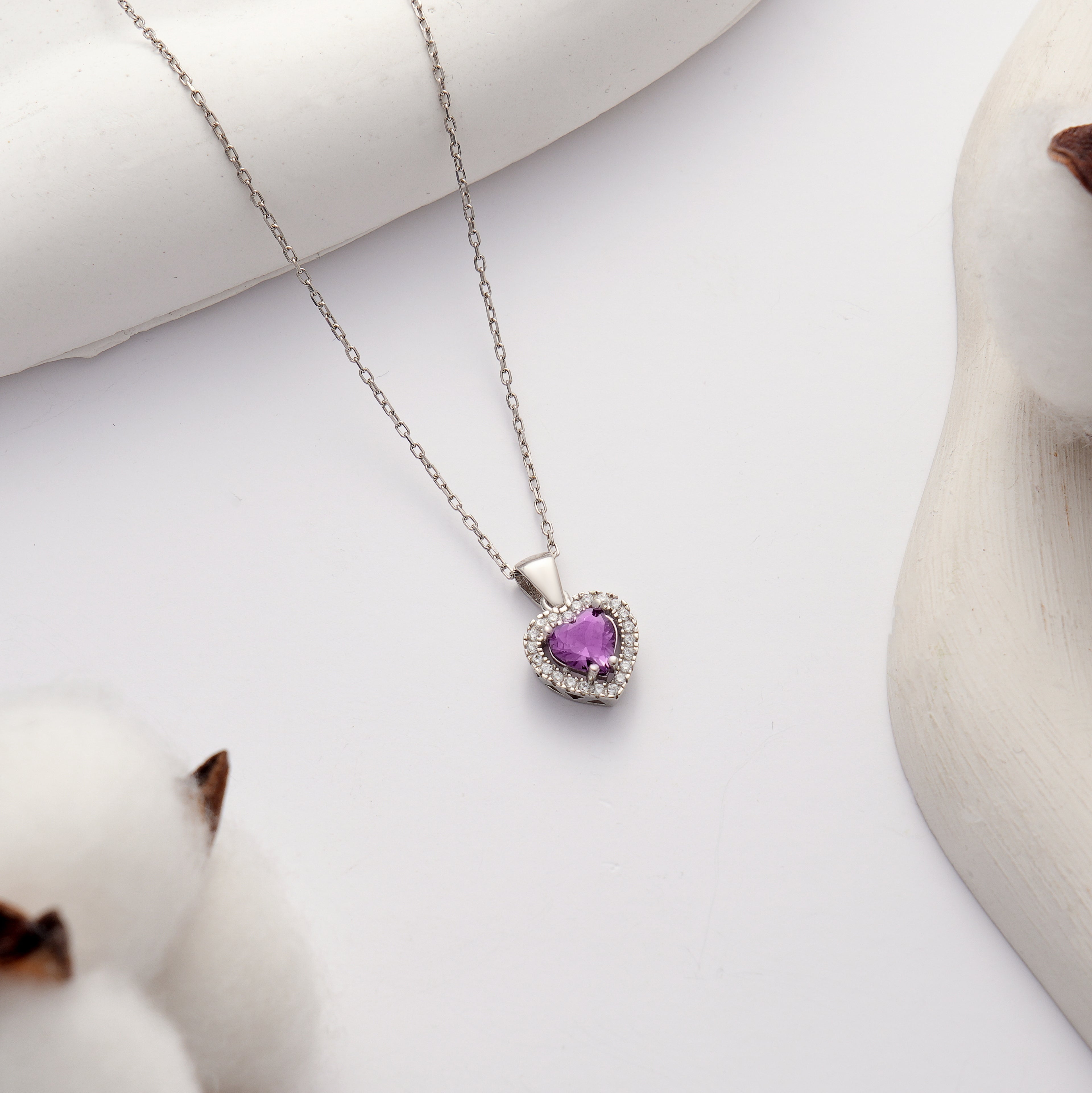 925 sterling silver heart pendant necklace featuring an amethyst color heart-shaped cubic zirconia and brilliant clear CZ halo.
