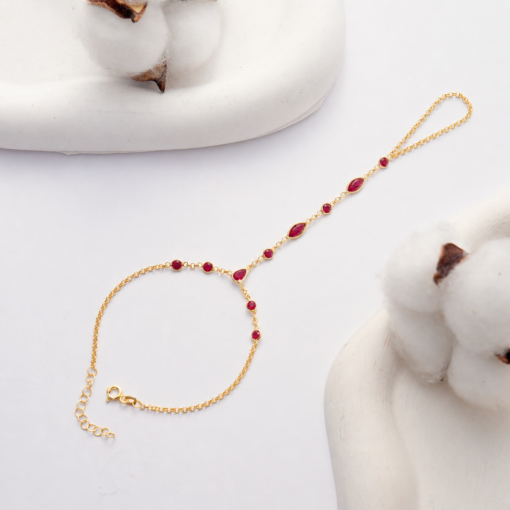 Rose Gold Plated Hand Chain Bracelet with Ruby Red Cubic Zirconia on White Background