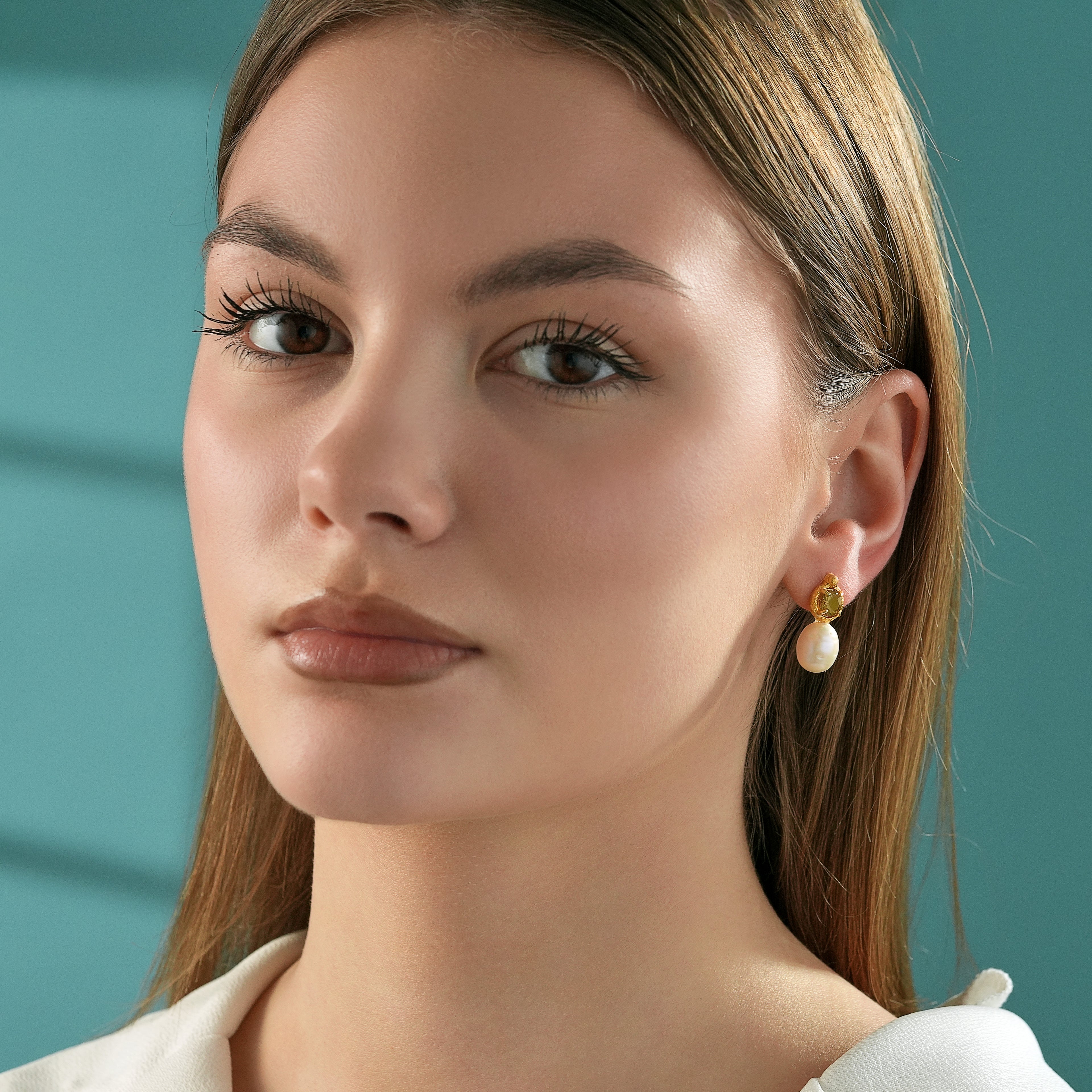Woman wearing elegant 14K gold plated sterling silver earrings with sparkling natural diaspore gemstones and freshwater pearl drops.